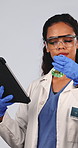 Woman, scientist and liquid in studio for chemistry, research and medical study with experiment. Female person, tablet or goggles with beaker, chemical reaction and testing sample on white background