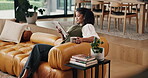 Happy woman, reading and relax with tablet in lounge, entertainment and chilling with coffee on couch. Reader, smile and internet connection for fiction ebook, online and person with tea in house