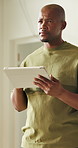 Black man, tablet and thinking in home for renovation, construction or interior design with vision. Planning, ideas and person with online layout or digital floorplan for house remodeling project 