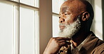 Black man, senior and thinking by window at home, contemplating or ponder with serious contemplation. Person, retired or perspective, nostalgia or remember with memory, insight or reflection at house