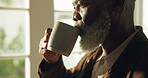 Thinking, coffee and relax with black man in home for reflection, beverage and wellness. Morning drink, mindfulness and calm with senior person in living room of house for weekend break and memory