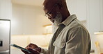 Tablet, scroll and glasses with black man in home for streaming service, movie search and media app. Online film platform, subscription and typing with mature person for connection and entertainment