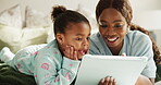 Mom, scroll and child with tablet in bedroom, elearning and watching educational cartoons on website. Family, home and black woman with girl on bed, smile and app subscription for online education