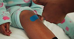 Child, injury and hands for thumbs up with bandage, bruise or first aid and help for knee in family home. Plaster, wound protection and wellness of kid with woman for healing, approval and recovery