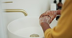 Healthcare, person and washing hands with soap in bathroom for germ removal, disinfection and cleanliness. Skincare, water and cleaning dirt in sink for bacteria safety, hygiene and wellness in home