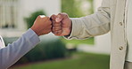 Parent, child and outdoor with hands for fist bump, secret handshake and support in relationship. Dad, kid and gesture in home backyard for deal, promise and bonding with connection on fathers day