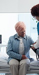 Consultation, blood pressure and nurse with senior woman in hospital with diagnosis or treatment. Hypertension tool, checkup and medical worker with elderly patient for cardiology exam in clinic.