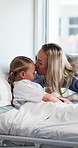 Hospital, visit and mom with child with kiss for comfort, support and bonding for recovery. Healthcare, family and mother with girl for love, compassion and affection for healing and medical service