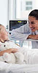 Smile, conversation and doctor with child in hospital bed for healing, support and talking for recovery. Healthcare, pediatrician and woman with good news for treatment, medical service and help girl