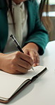 Notebook, writing and hands of businesswoman in office with finance research, appointment or schedule. Journal, agenda and female financial manager with notes on investment planning in workplace.