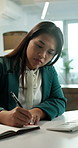 Notebook, writing and businesswoman in office with research, appointment or schedule for finance report. Journal, agenda and female financial manager with notes on investment planning in workplace.