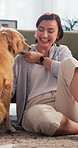 Smile, relax and woman with dog in home for bonding, companionship or adoption in living room. Treats, connection and female person with golden retriever puppy for loyalty, safety and care in house.