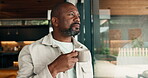 Thinking, coffee and window with black man in home for reflection, beverage and weekend break. Perspective, self care and morning drink with person in living room of apartment for relax and vision