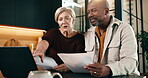Budget, documents and laptop with interracial couple on sofa in home living room for planning. Computer, paperwork and pointing with mature people in apartment for financial discussion or review
