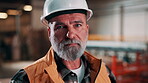 Helmet, carpenter and face of man in workshop for woodwork, manufacturing and joinery. Furniture factory, restoration and craftsmanship with mature person in warehouse for safety gear and timber