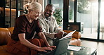 Happy, finance and couple with laptop in home for budget planning, report or expenses together. Interracial relationship, man and woman with documents for financial audit, tax or analysis in house