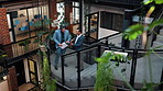 People, discussion and tablet in office with sustainable business, planning or research for project. Men, tech and conversation on stairs for eco friendly goals, environmentalist advice and strategy.