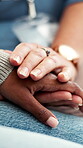 Doctor, sympathy and holding hands with patient in hospital, healthcare and comfort after diagnosis.Clinic, consultation and medical professional with empathy for person, wellness or healing support