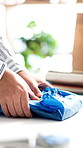 Hands, package or sticker on wrapping in clothing store for gift, sale and shipping preparation. Boutique, pack or woman with label for retail order process, fashion or distribution in small business