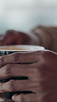 Hands, relax and person at cafe with coffee, start day and caffeine drink for morning routine. Black man, drinking and restaurant with warm beverage, espresso and hospitality for customer experience