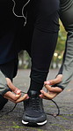 Exercise, hands and athlete tie shoes at park to start fitness, cardio preparation and safety. Outdoor, person and getting ready with sneakers for runner comfort, morning wellness and health practice
