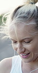 Outdoor, smile or woman with earphones for fitness, streaming popular song or weekend cardio routine. Wind, happy or runner with music for practice motivation, audio tech or training playlist in city