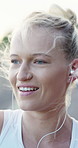 Outdoor, dancing and woman with earphones for fitness, streaming song and smile for weekend cardio. Wind, happy and runner with music for practice motivation, audio tech and training playlist in city