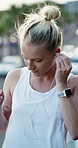 City, fitness and woman with earphones on break, connection and listening to music with subscription. Happy, athlete and person with health goals, wellness and streaming audio with tech on bridge