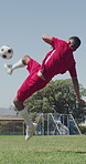 Soccer, kick and man with ball on field for game, practice match and competition. Sports, fitness and player jumping in air for trick, goal and skills for training, athlete and exercise for contest