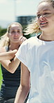 Women, personal trainer and fitness with group outdoor for health, wellness or motivation. Female person, coach or exercise instructor with smile, team and warm up for physical activity in park 