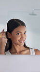 Mirror, beauty and woman brushing hair in bathroom for grooming, self care or morning routine. Smile, reflection and person with haircare for keratin treatment, hairstyle and maintenance in home