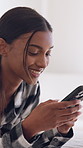 Phone, relax and woman in home for texting, social media or chatting on mobile app on weekend. Happy, technology and female person with cellphone for online communication with website in apartment.