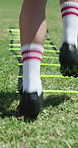 Athlete, legs and soccer ball outdoor for training, cardio exercise and practice technique to score goal. Person, feet and football player on field for running drill, sports performance and workout.