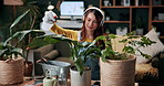 Gardening, woman and watering plants with headphones in home for growth, development or routine. Podcast, gardener or soil hydration with spray bottle for houseplant care, green hobby or maintenance