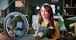 Ring light, plants and woman in home and talking for advice, botany tips and floral care for vlog. Influencer, content creator and person record with houseplant for hobby, gardening and social media