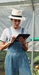 Farmer, research and woman with tablet in farm, agriculture and crop management on website or online. Mature person, typing and monitor climate for plant growth, happy and quality assurance report