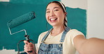 Woman, face and painting for home renovation vlog, filming or record with selfie, smile and roller. Interior design, house and Asian creator with funny expression, portrait and painter live stream