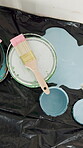 Paint, mess and tools for renovation in new house, maintenance or remodeling project with paintbrush. Above, spill and equipment for room transformation, interior design and creative home improvement