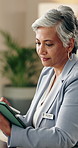 Woman, doctor and reading in office with tablet, research and medical results for diagnosis. Smile, mature person or workplace with digital, healthcare report and telehealth information for treatment