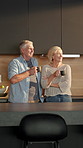 Talking, kitchen and senior couple with coffee, conversation and bonding on weekend morning in home. Retirement, marriage and man with woman with drink, discussion and connection for planning day