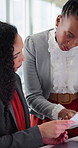 Team, research and women with paperwork in office, budget review and financial planning with laptop. Business people, talking and collaboration with document, typing and investment opportunity on web