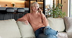Woman, phone call and talking on couch in lounge, relax and communication with contact or discussion. Mobile, chat and mature person with smile, chill and gossip with tech and conversation in home