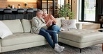 Couple, relax and talking in home with phone, love and browsing website for bonding together. Mature people, rest and discussion at house with mobile app, social media and streaming for weekend break