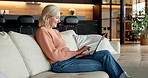 Typing, laptop and smile with old woman on sofa for social media, ebook subscription and website info. Online library, retirement and senior person in home, tech for communication and connection