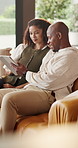 Home, black couple and relax with tablet for chat, online message and video for entertainment in lounge. Smile, man and woman with technology, communication or funny comment for bonding together