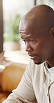 Frustrated, man and sofa with argument in home for fight, conflict or toxic relationship. Upset, male person or ignore with stress or regret for affair, disagreement or disappointment in house