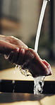 Water, kitchen and woman washing hands in home for hygiene, wellness and self care for sanitizing. Faucet, disinfection and female person with cleaning skin for germs, dirt and bacteria removal.