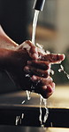 Washing, hands and tap water in home with disinfection, bacteria prevention and hygiene for wellness. Person, cleaning skin and healthy habits in house with sink, germ protection and dirt removal.