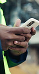 Man, engineer and hands typing with phone for planning construction project, infrastructure and network. Architect, tech and employee with communication, message and check schedule for renovation