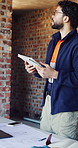 Tablet, inspection and man on laptop at construction site for progress report, building code or RFI. Masonry evaluation, architect and tech for zoning compliance, quality control and risk assessment